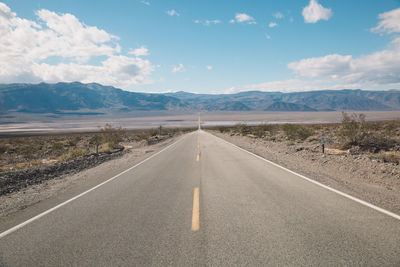 Road amidst landscape against sky