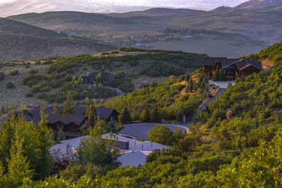 High angle view of houses and trees by mountains