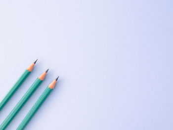 Close-up of colored pencils against white background