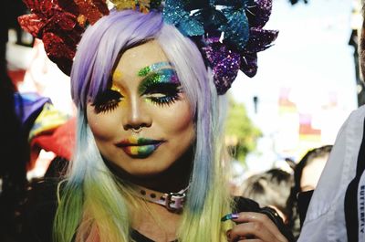 Portrait of young woman with make-up and wearing costume at carnival