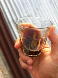 Close-up of person holding glass of drink