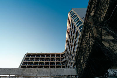 Low angle view of old building against clear blue sky