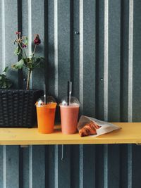 Close-up of food with drinks by plants on table