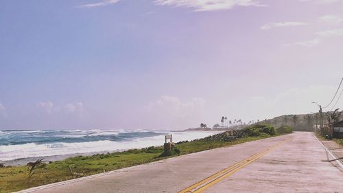 Road by sea against sky