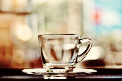 Close-up of empty glass cup on table