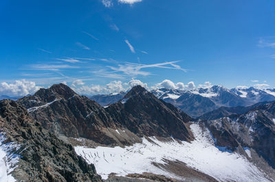 Scenic view of snowcapped mountains against blue sky