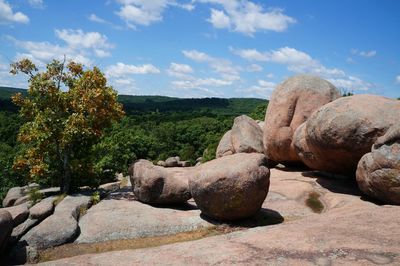 Statue on rock against sky