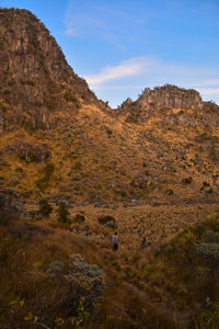 Scenic view of land and mountains against sky