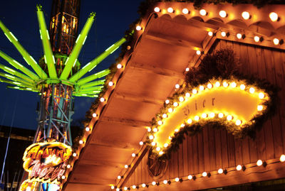 Low angle view of illuminated lights at night