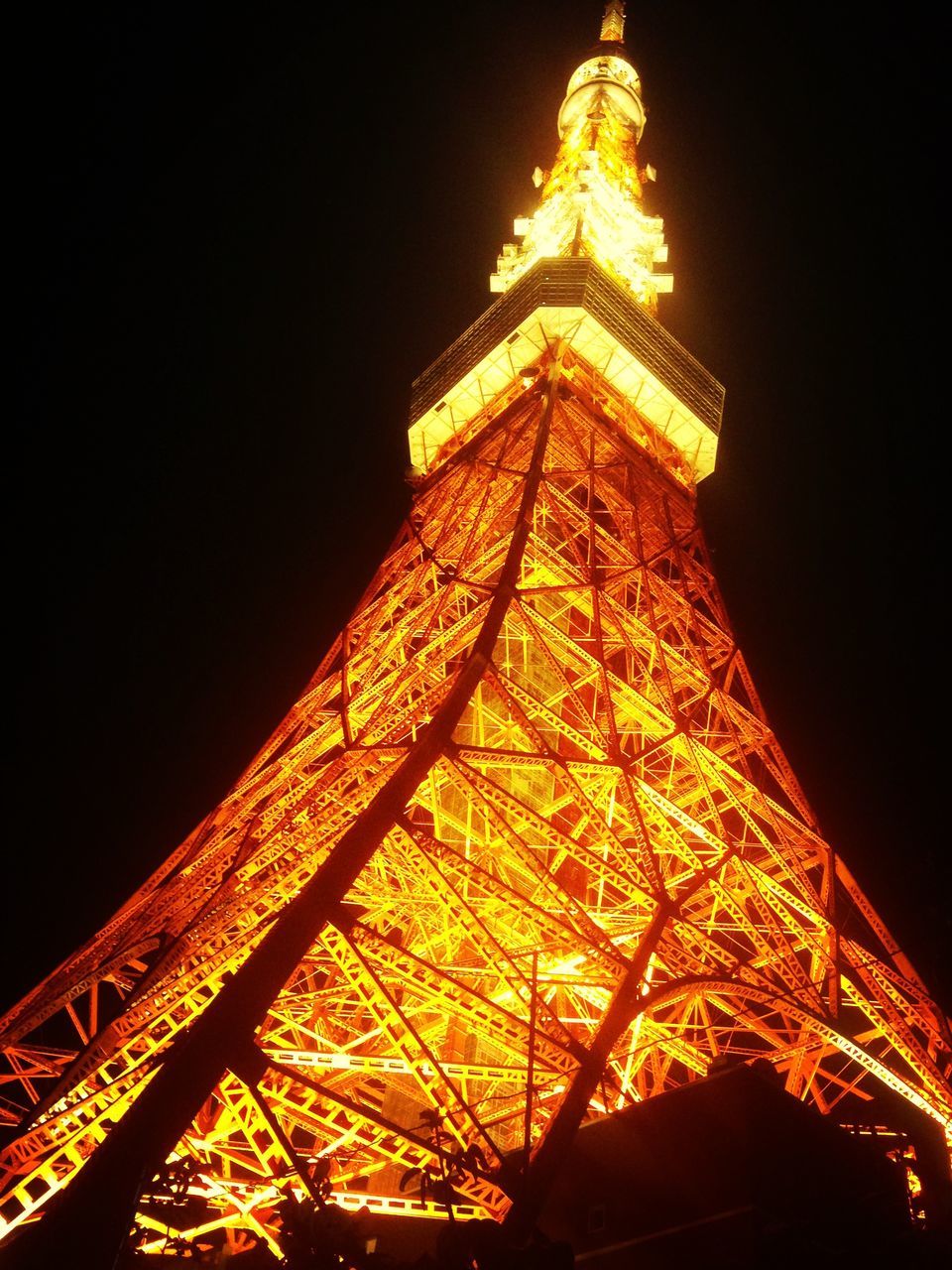 architecture, low angle view, night, built structure, illuminated, famous place, international landmark, travel destinations, tower, tourism, eiffel tower, capital cities, travel, building exterior, clear sky, tall - high, city, sky, copy space, outdoors