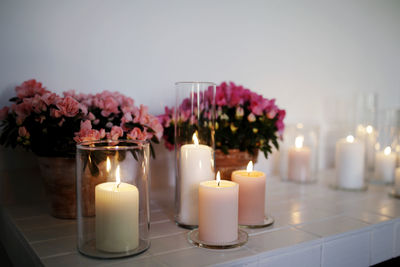 Close-up of illuminated candles on flower