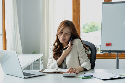 Portrait of young businesswoman working at office