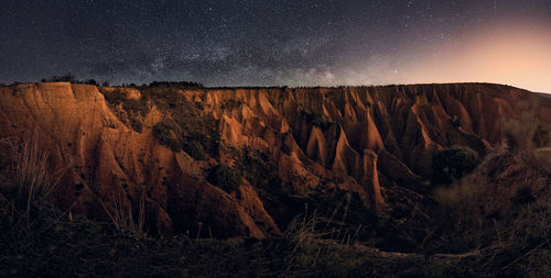 Scenic view of rock formations against sky at night. milkyway panoramic