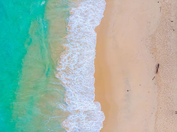 High angle view of waves rushing towards shore