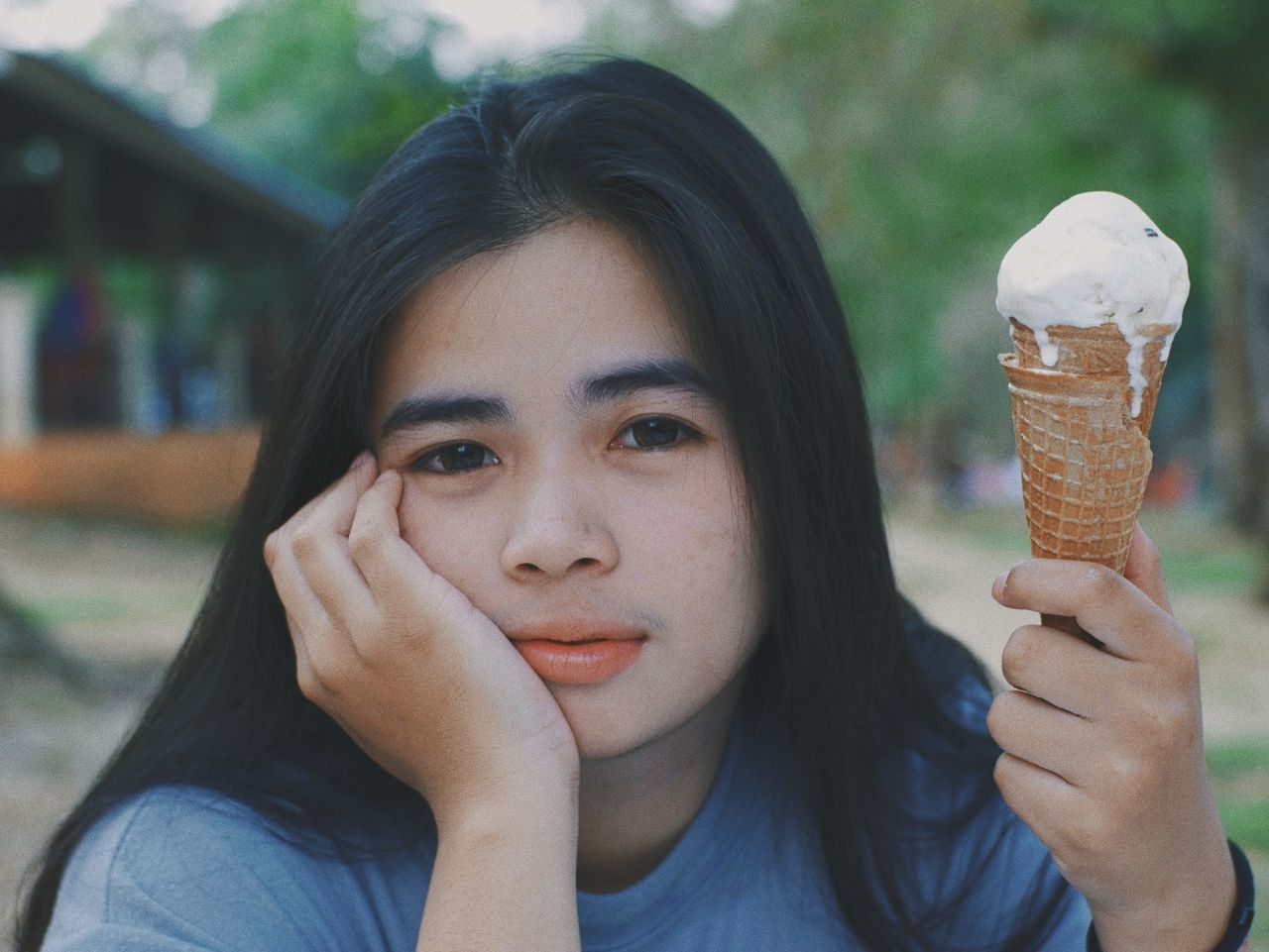 portrait, one person, headshot, front view, real people, focus on foreground, sweet, sweet food, ice cream, frozen food, frozen, holding, looking at camera, casual clothing, leisure activity, food and drink, dessert, lifestyles, hair, temptation, outdoors, hairstyle, teenager