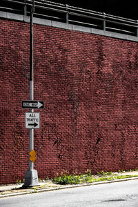 Road sign on wall of building