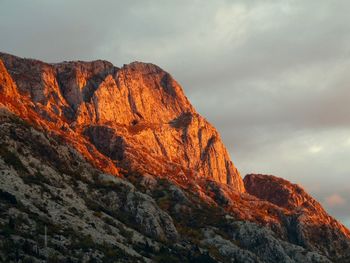 Low angle view of rock formation against sky