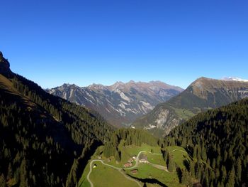 Panoramic view of mountains against clear blue sky