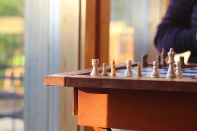 Cropped image of person by chess board