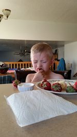 Boy eating food at home