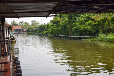 Scenic view of river amidst trees and buildings