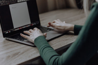 Hands of young girl are typing in a laptop. workspace at home. online business. distance learning. 