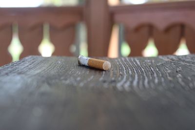 Close-up of cigarette on wood