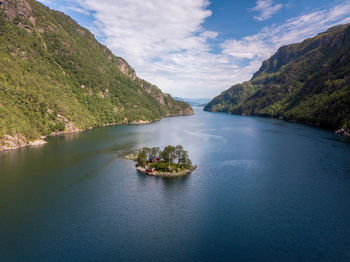 Scenic view of river amidst mountains against sky