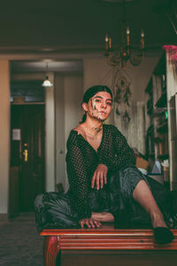 Portrait of young man sitting on table