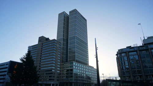 Low angle view of modern buildings against clear sky