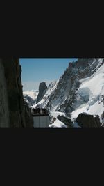 Scenic view of snow covered mountains against sky