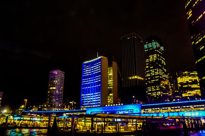 Illuminated buildings against sky at night