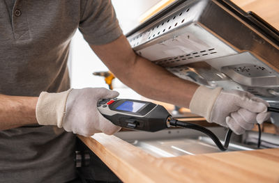 Midsection of man working in workshop