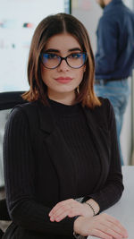 Portrait of young woman sitting at home