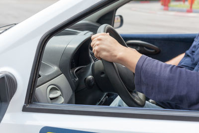 Midsection of man sitting in car