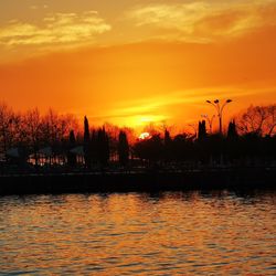 Scenic view of lake against romantic sky at sunset