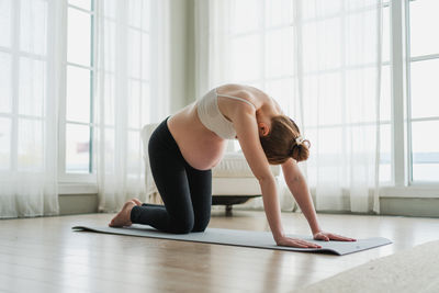 Young woman exercising in gym