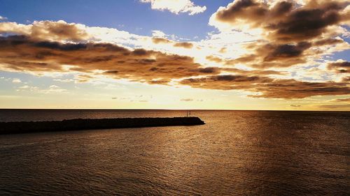 View of calm sea against cloudy sky