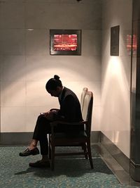 Man sitting on chair at home