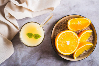 Close up of vegetarian smoothie made from rice milk and orange in a glass on the table top view