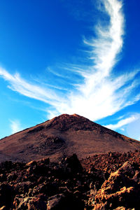 Scenic view of mountain against blue sky