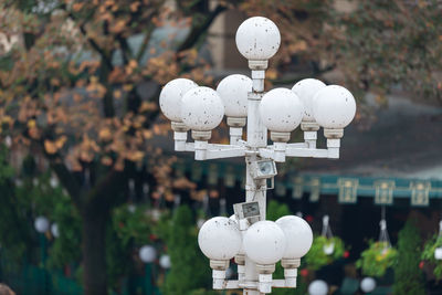 Close-up of lighting equipment against trees in park