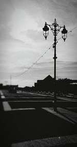 Electricity pylon against sky at sunset