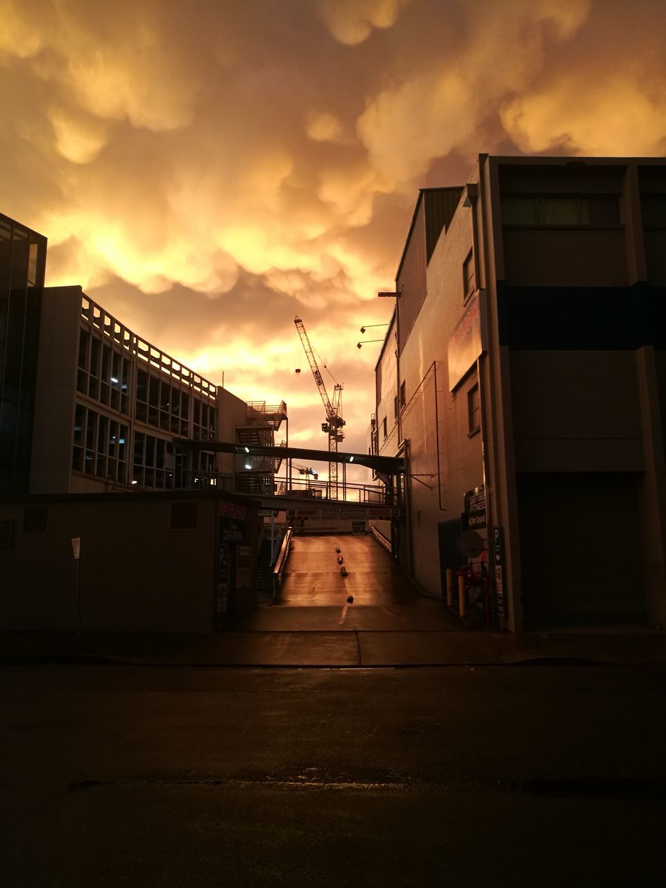 architecture, cloud - sky, building exterior, sky, built structure, sunset, building, city, nature, residential district, no people, the way forward, orange color, outdoors, street, direction, water, empty, dramatic sky