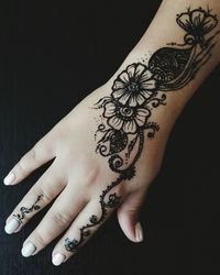 Close-up of woman hand with henna tattoo