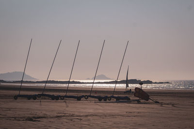 Sailboats on sea against sky during sunset