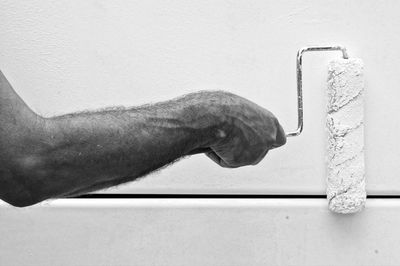 Black and white photo of arm painting with paint roller