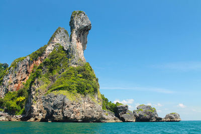 Rock formation in sea against sky