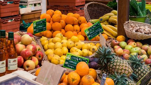 Various fruits in basket for sale at market stall