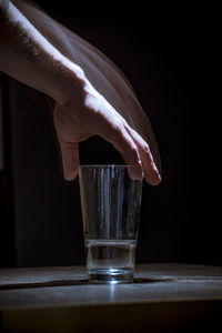 Close-up of hand holding glass of water